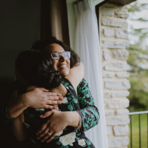 Two wedding professionals, both women of colour, embrace